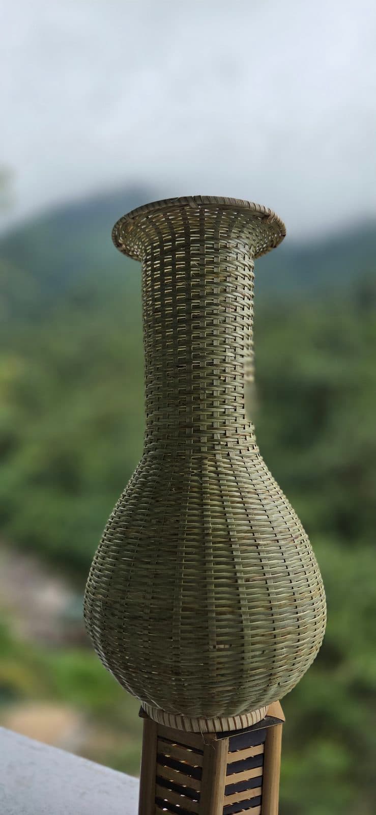 Tall handwoven bamboo vase with flared neck